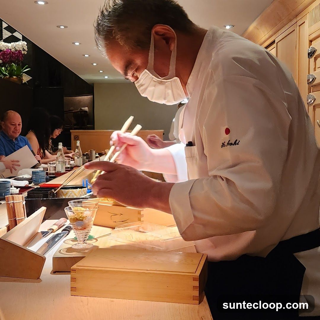 Chef preparing food at a sushi bar