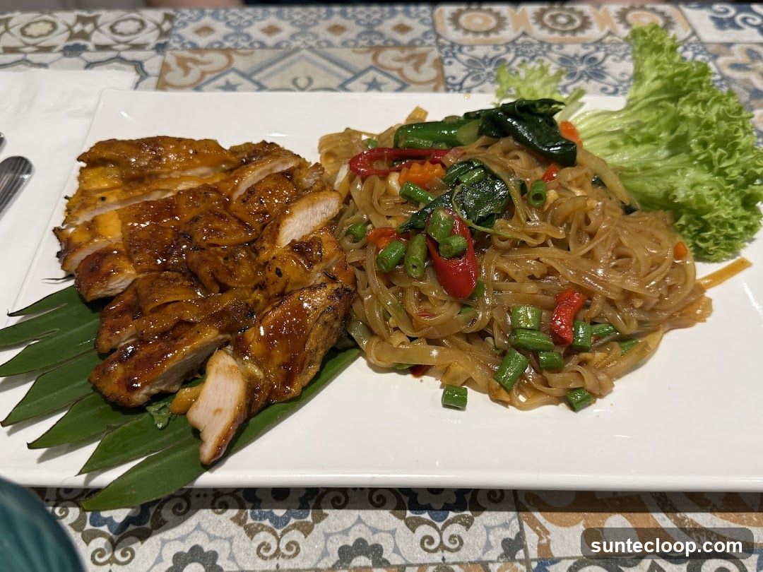 Sliced grilled chicken with noodles