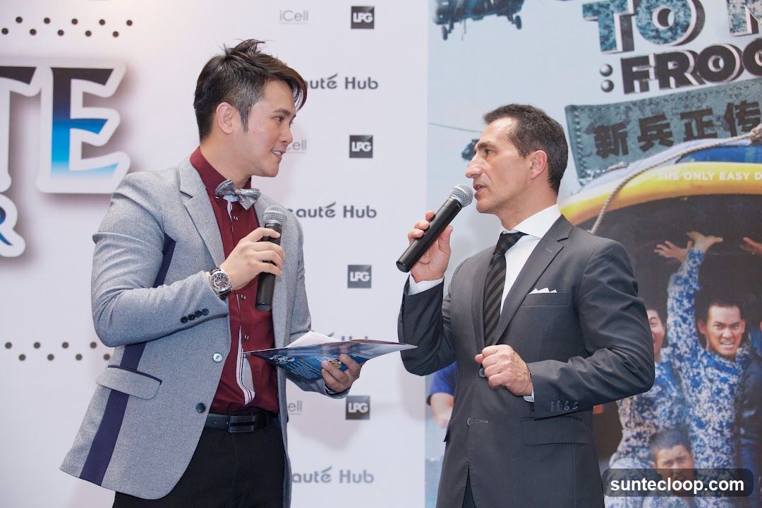 Two men with microphones at an event