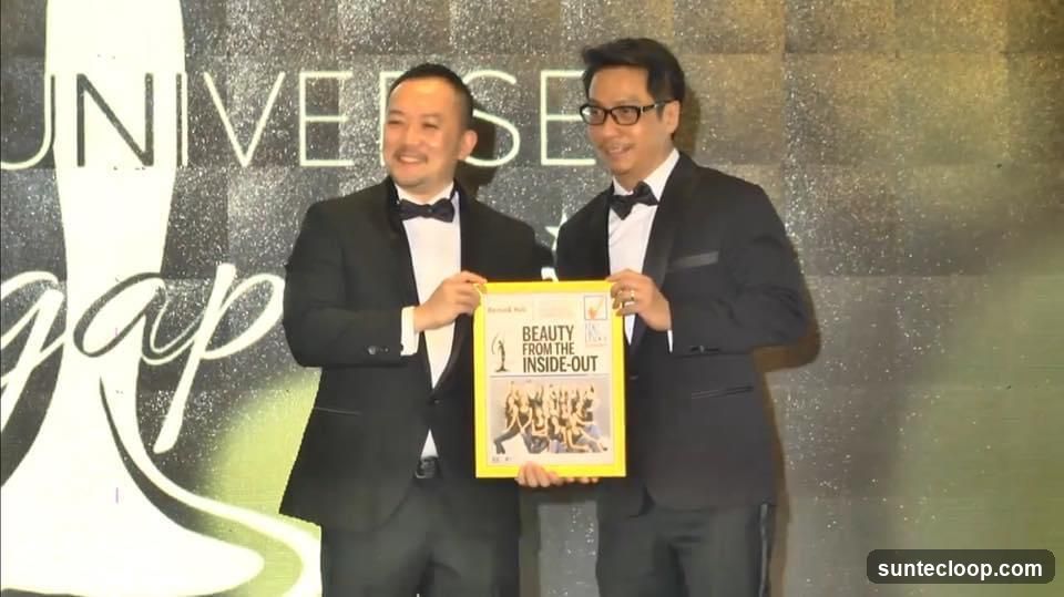 Two men holding a framed award