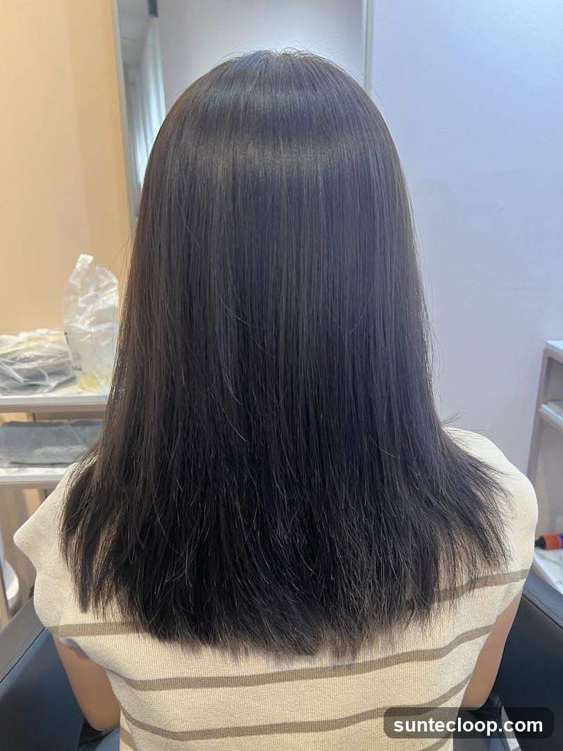 Back view of a person with dark, straight hair