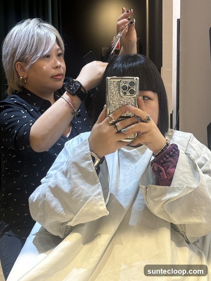 Hairdresser cutting client's hair