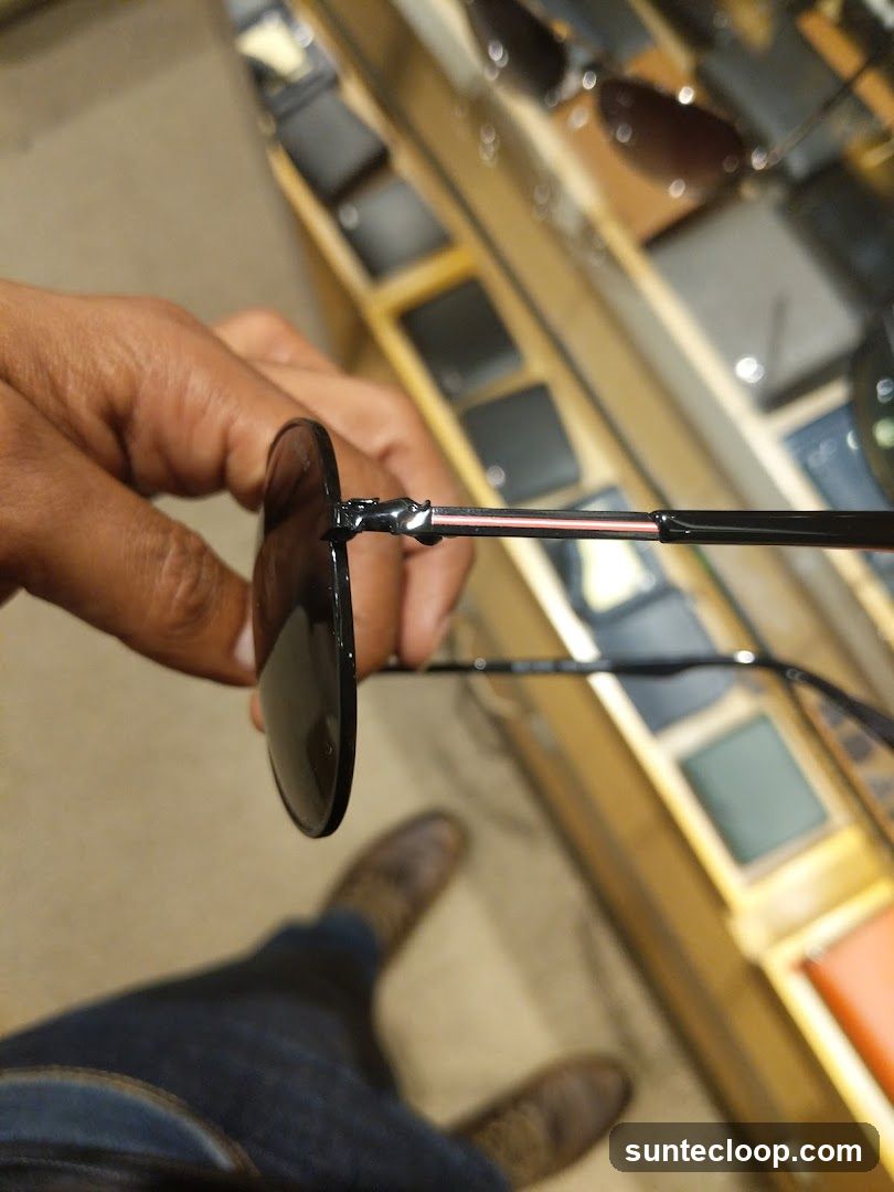 Person holding sunglasses in a store