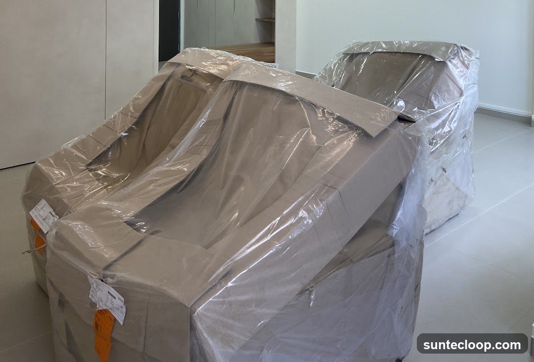 Two chairs wrapped in protective plastic