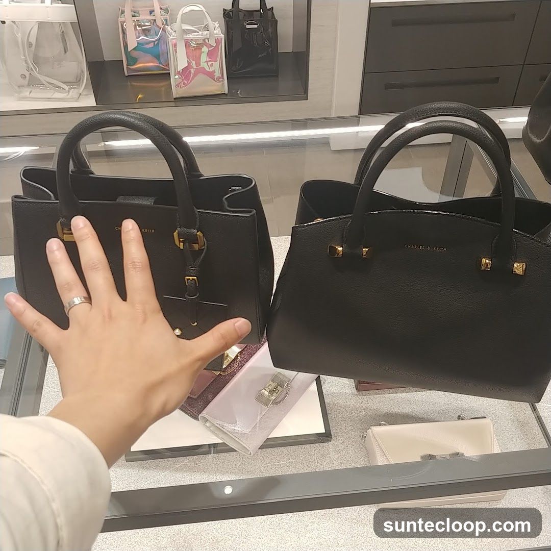 Hand in front of handbags
