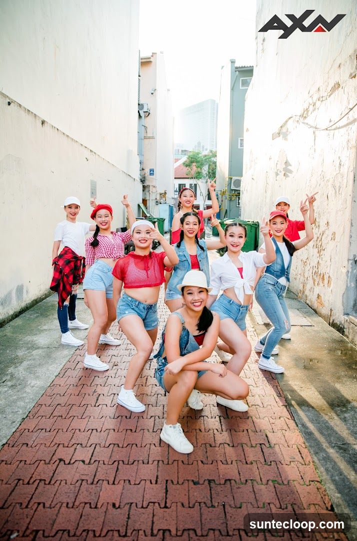 Group of young women posing in an alley