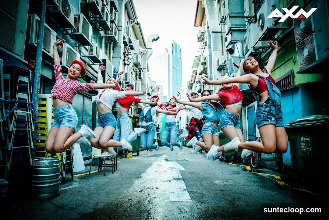 Group of young women jumping in an alley