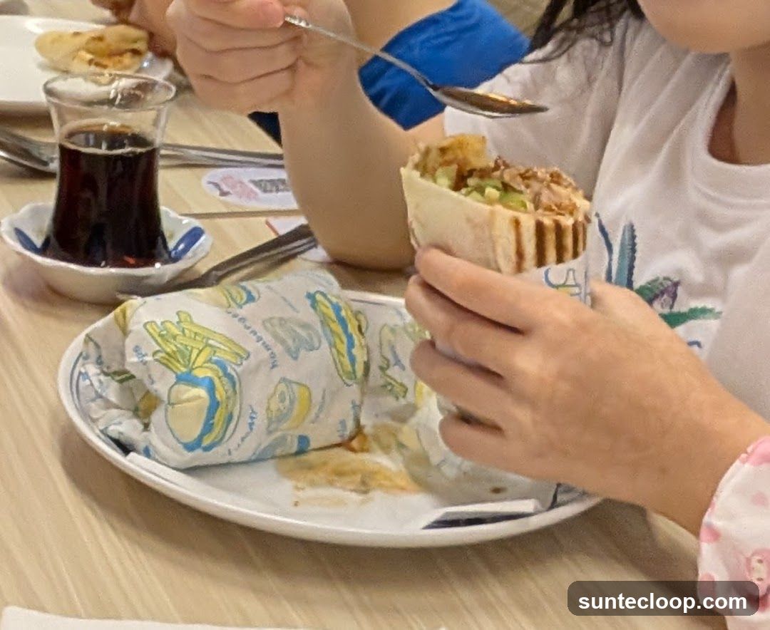 People eating shawarma and drinking tea