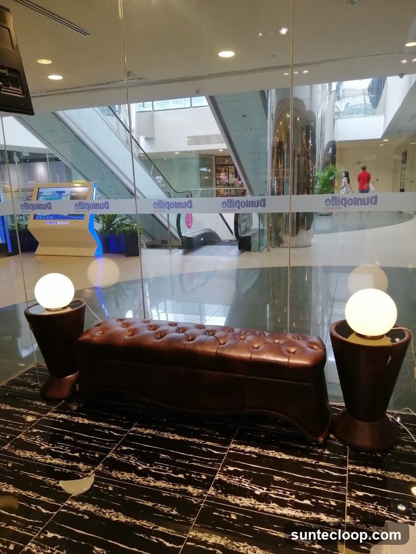 Interior of a shopping mall with escalators and seating