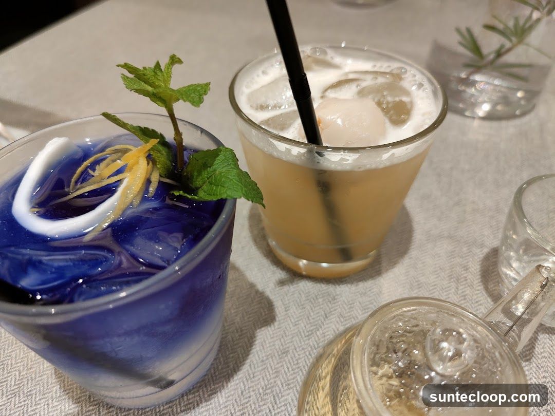 Two colorful cocktails on a table