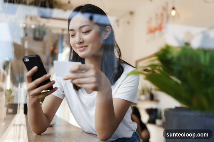 Woman using phone and credit card