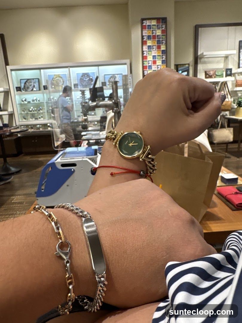 Person wearing watches and bracelets in a store