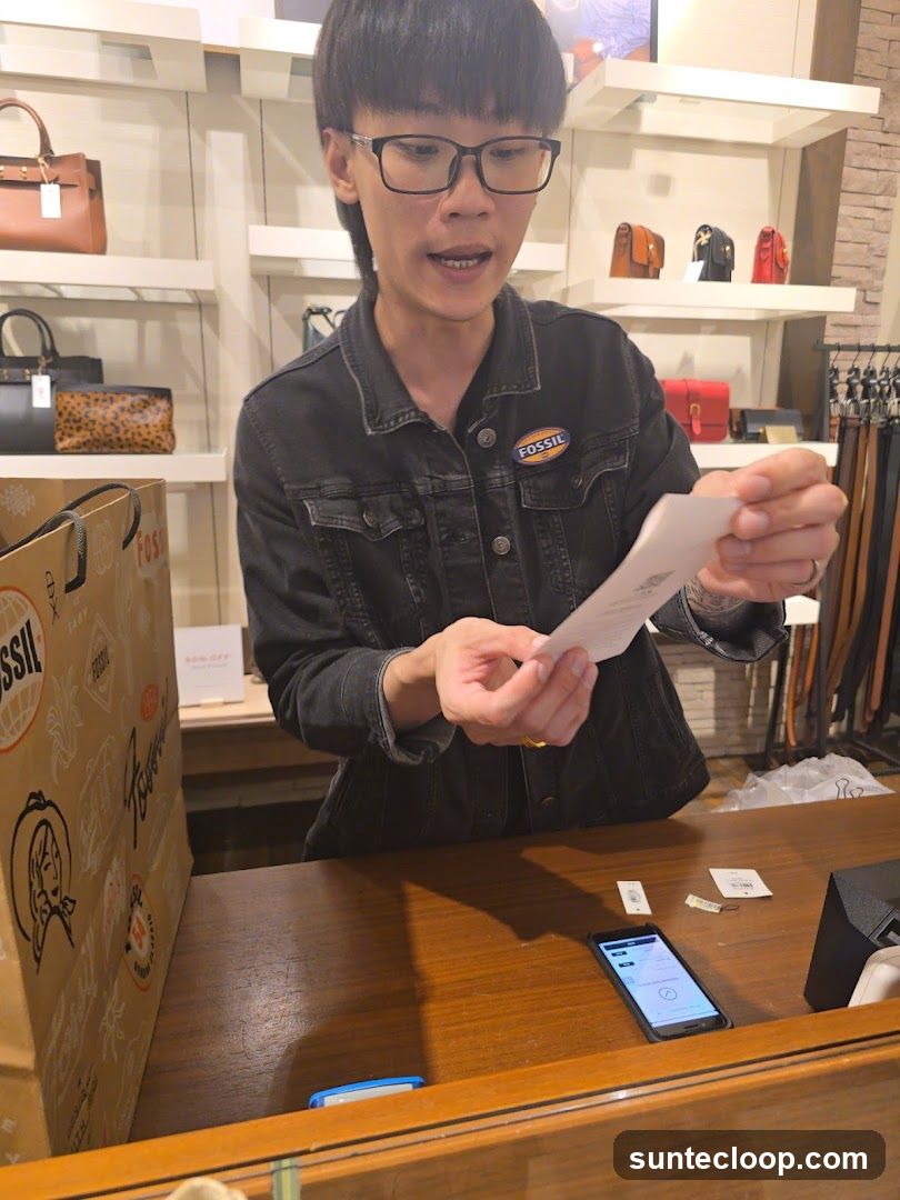 Salesperson holding a receipt at a counter