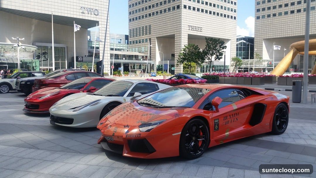 Luxury Cars Lined Up Outside Modern Buildings
