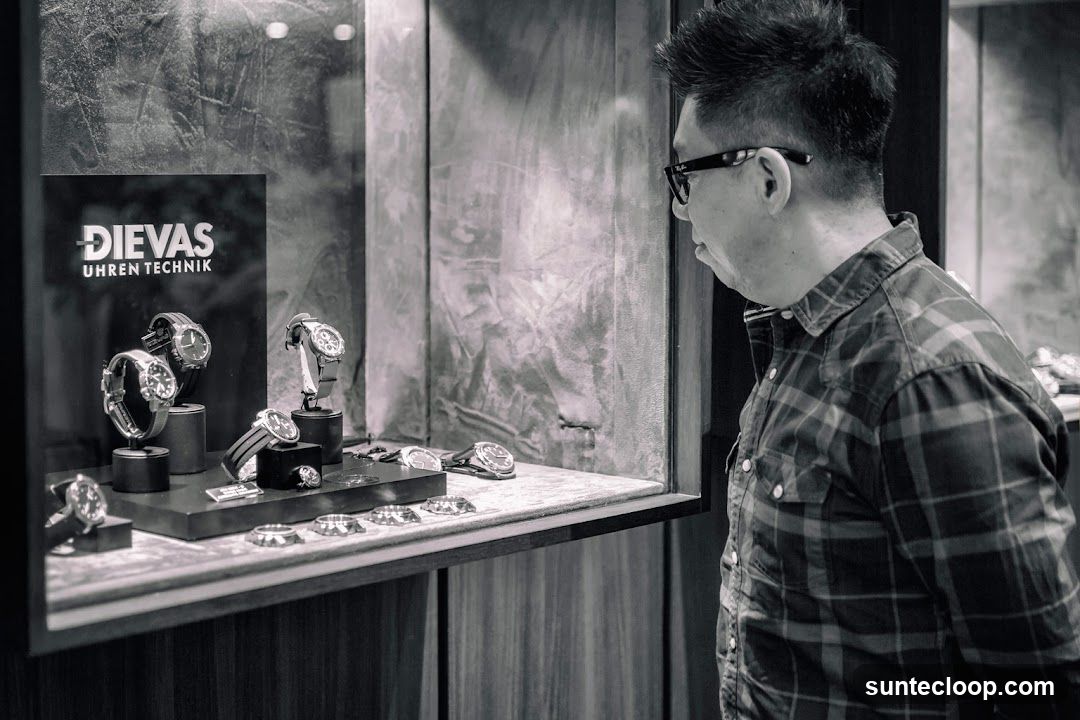 Man looking at watches in a display case