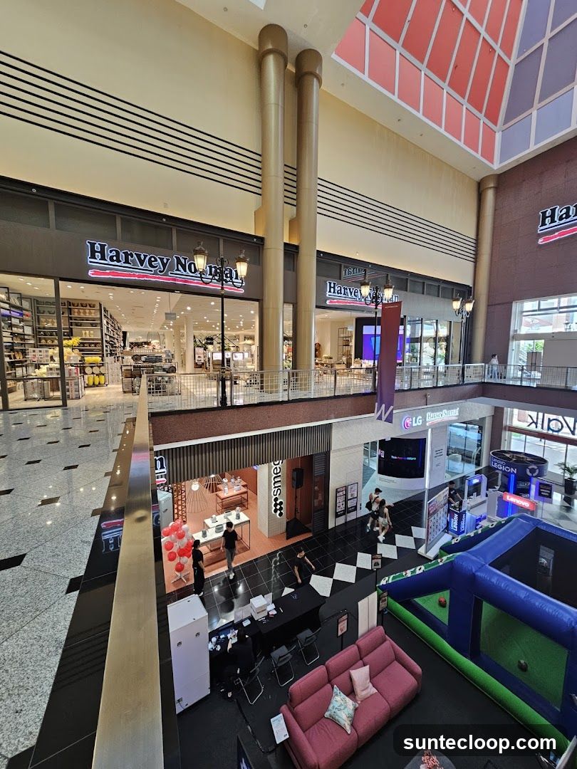 Shopping mall interior with various stores and attractions