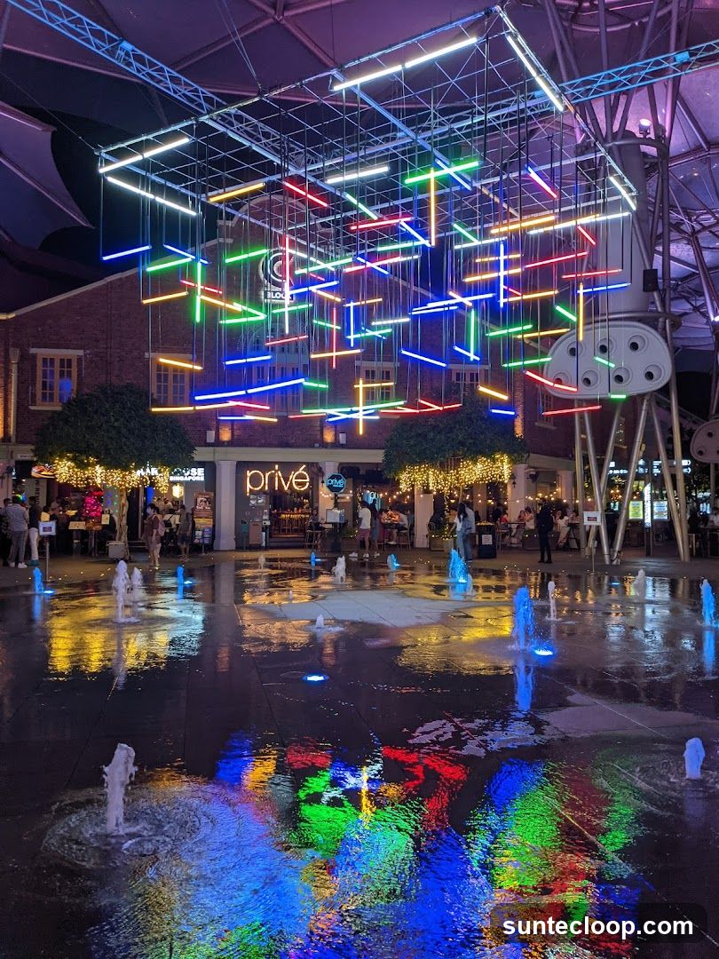 Outdoor plaza with light installation and fountains
