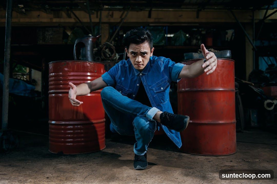 Man posing between barrels