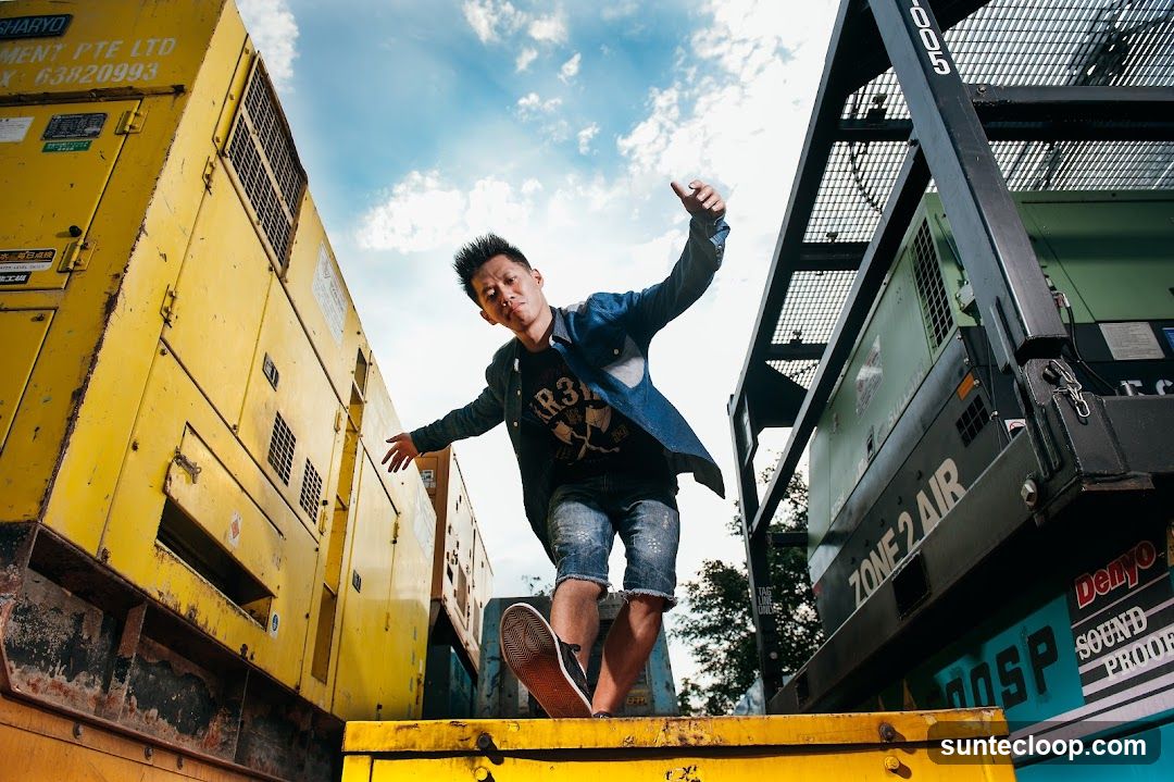 Man posing between generators