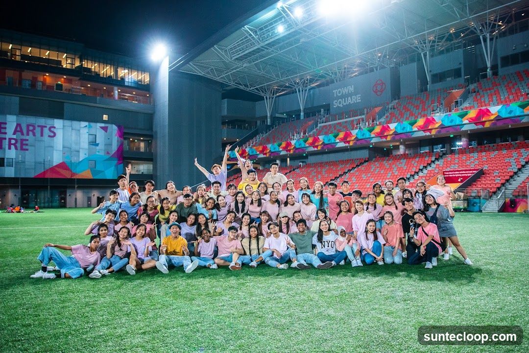 Large Group Poses on Sports Field