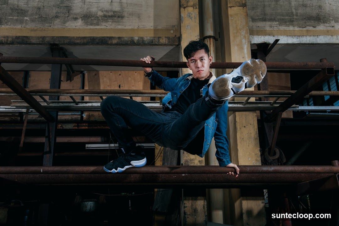 Man in denim jacket posing on metal bars