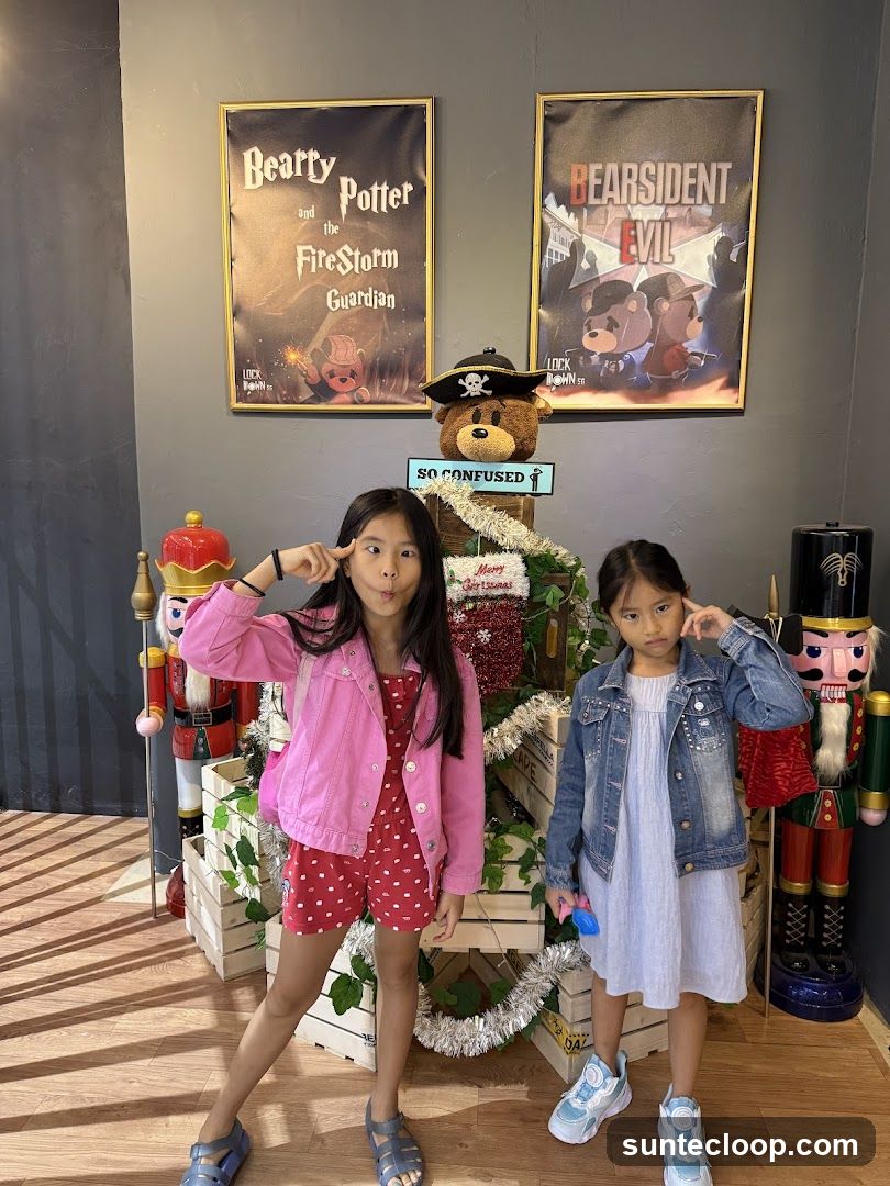 Two girls posing in front of posters