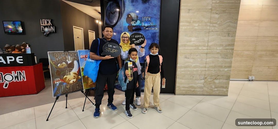 Family Posing with Signs at Escape Room