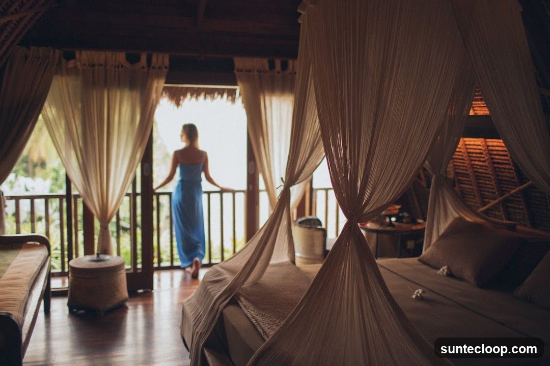 Bedroom with Canopy Bed and Balcony View