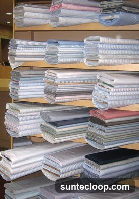 Stacks of folded fabric on shelves