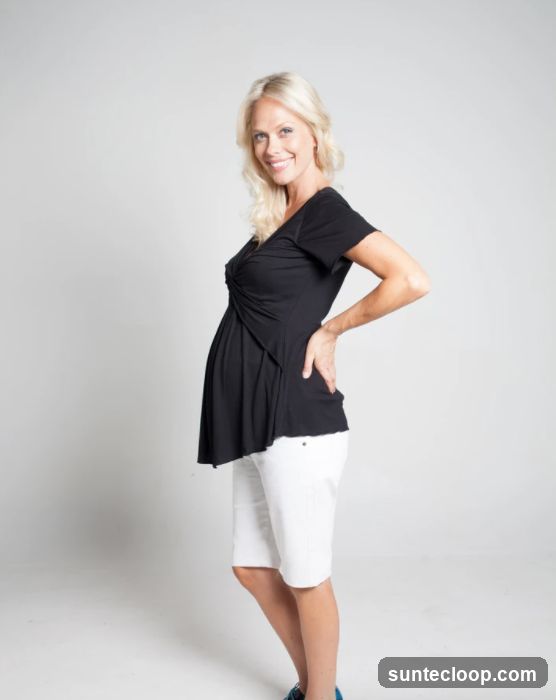 Pregnant woman in black top and white shorts