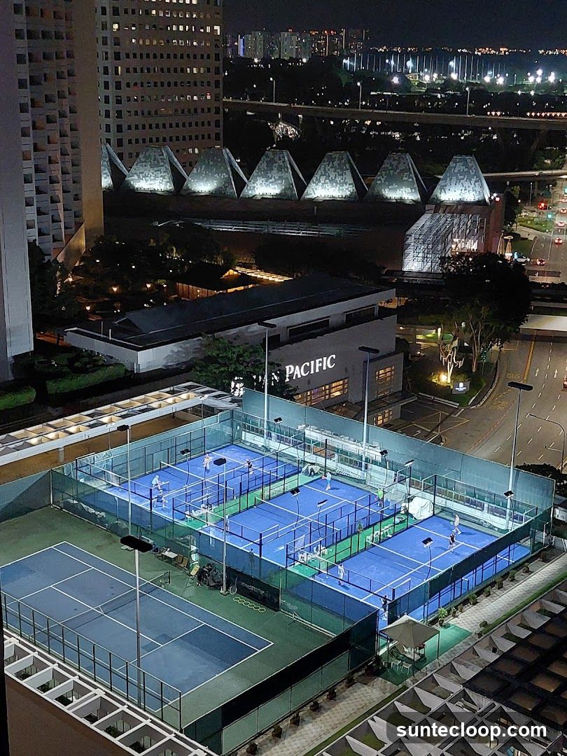 Night view of sports courts and city skyline