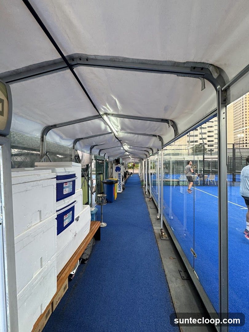 Covered walkway next to a padel court
