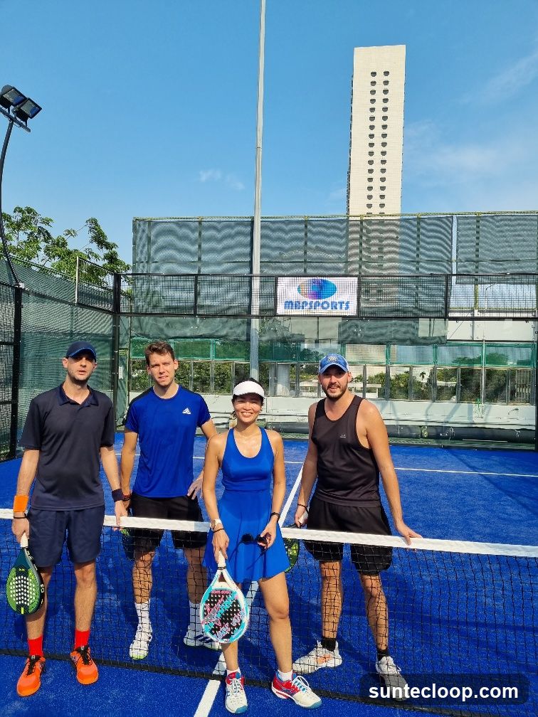 Four people on a padel court