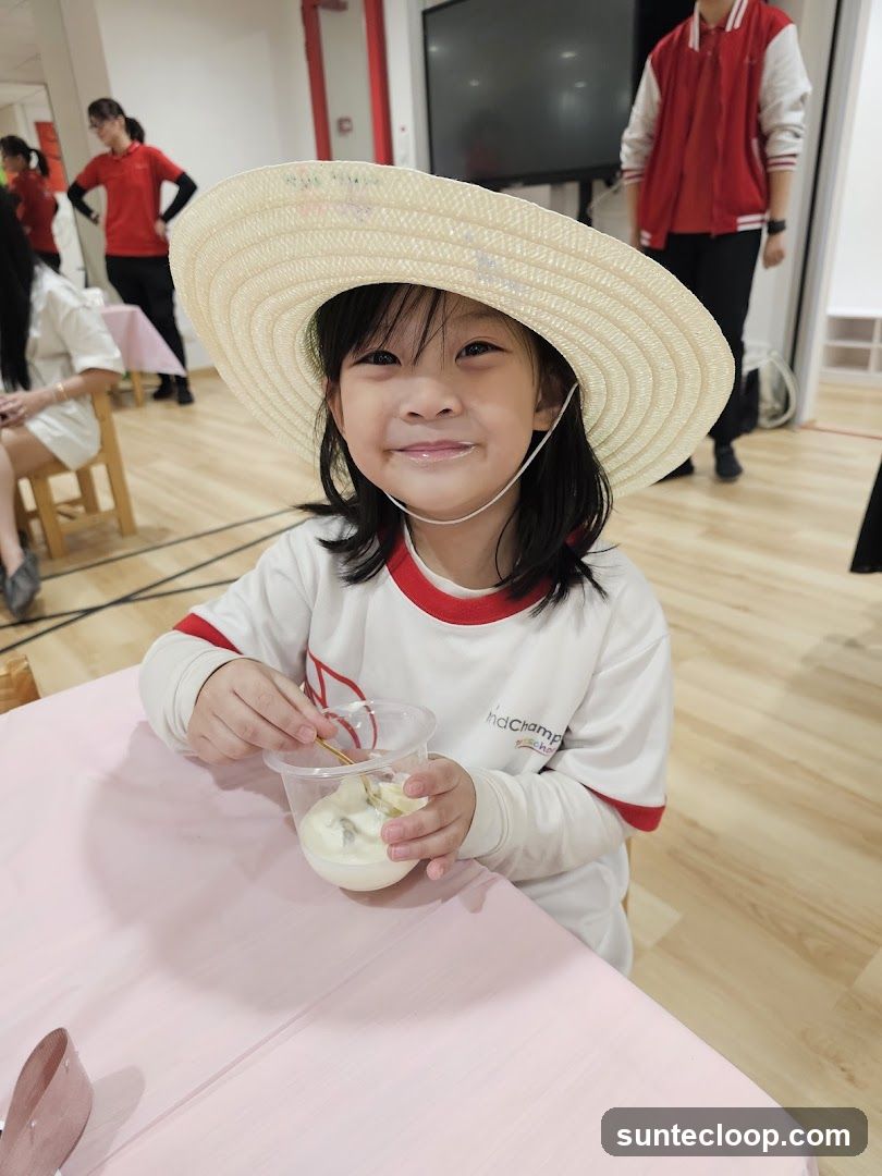 Child in a straw hat eating ice cream