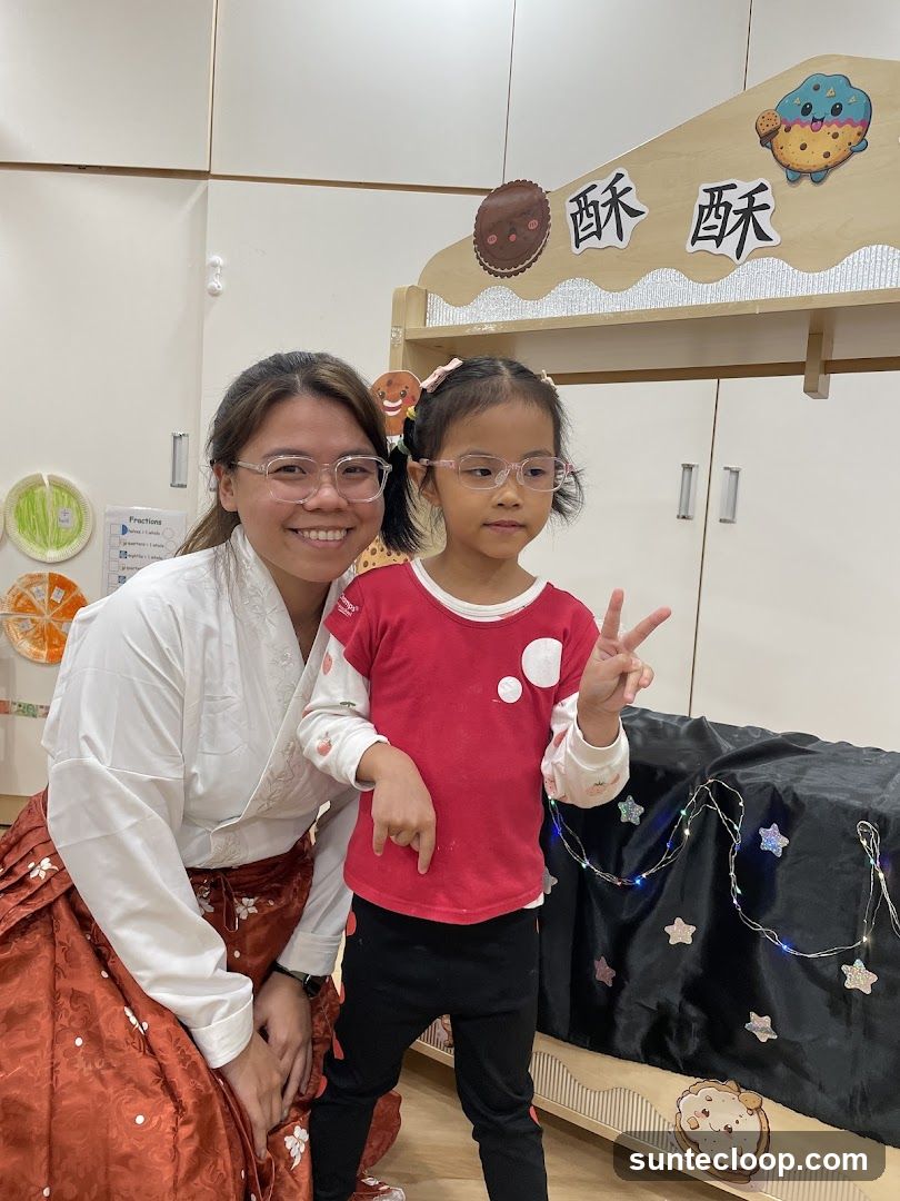 Woman and child posing in front of a cookie-themed backdrop