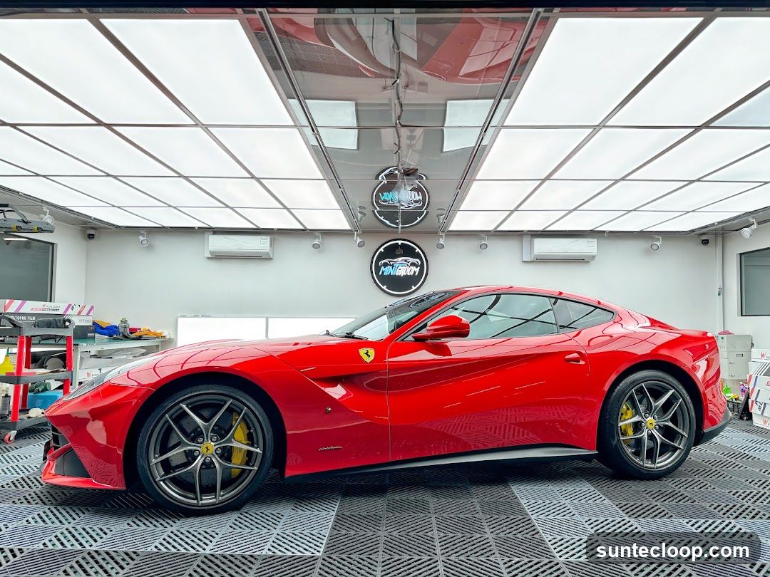 Red Ferrari in a brightly lit garage