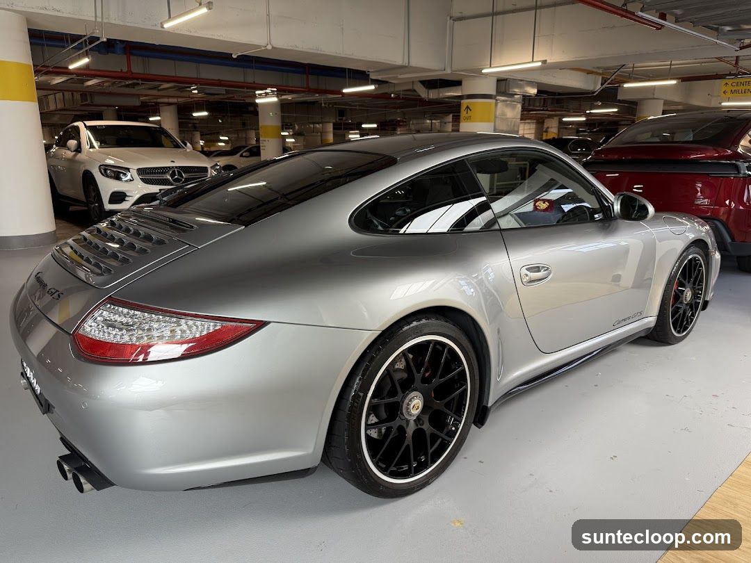 Silver Porsche Carrera GTS in Parking Garage
