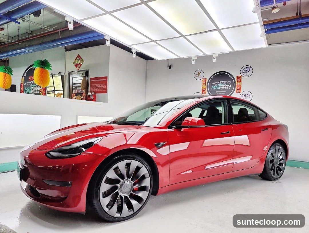Red Tesla in a Car Wash Bay