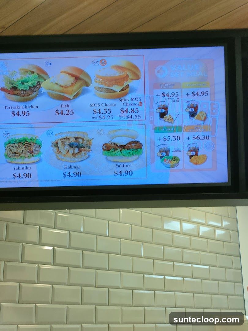 A digital menu board displaying various burger options and set meals.