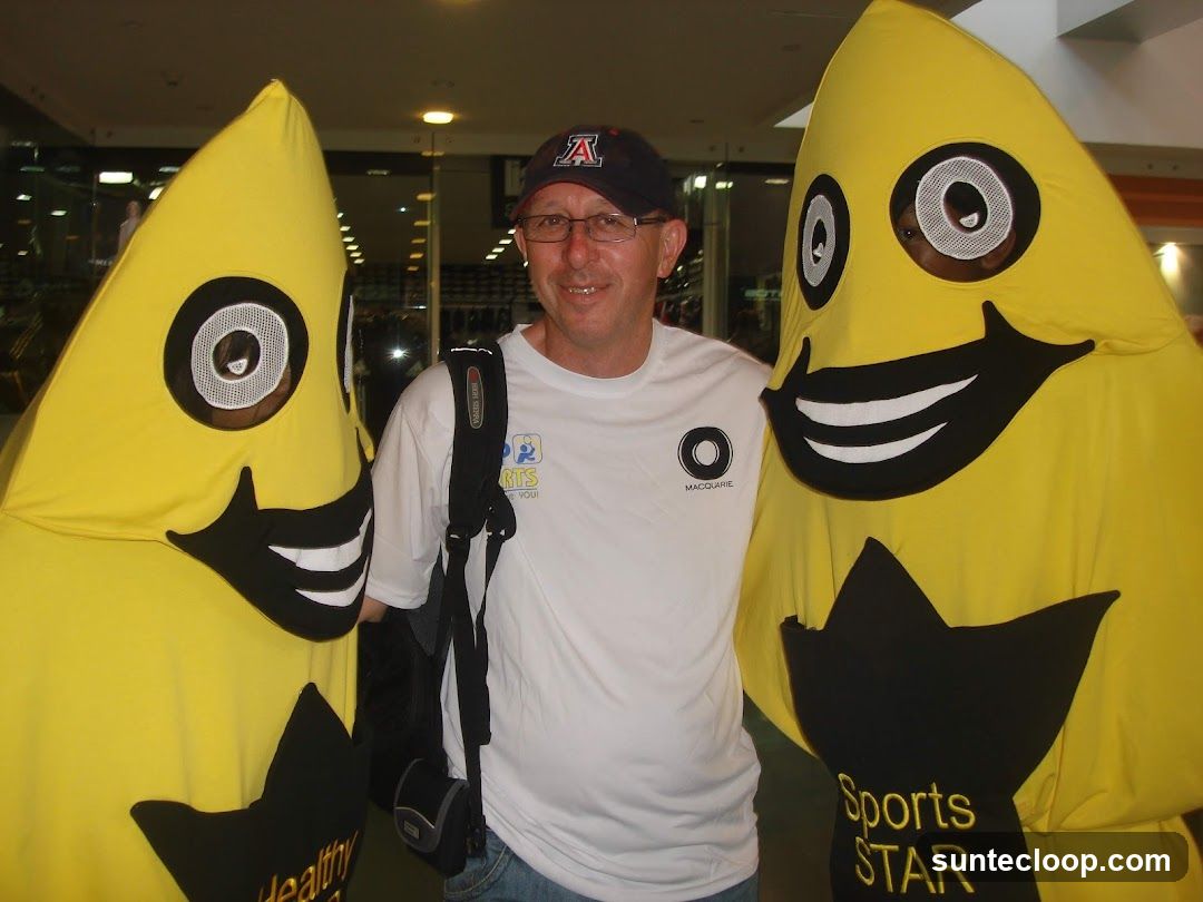Man Poses With Mascots
