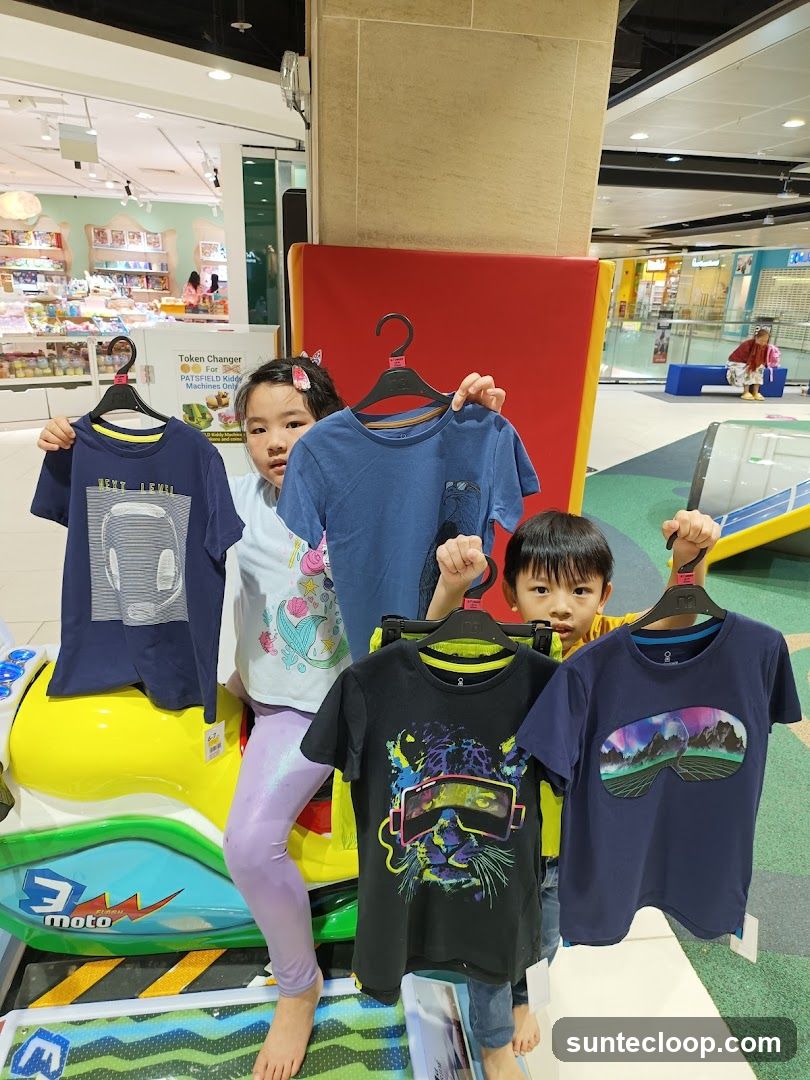 Children holding t-shirts