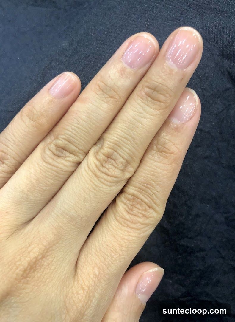 Hand with clear nail polish