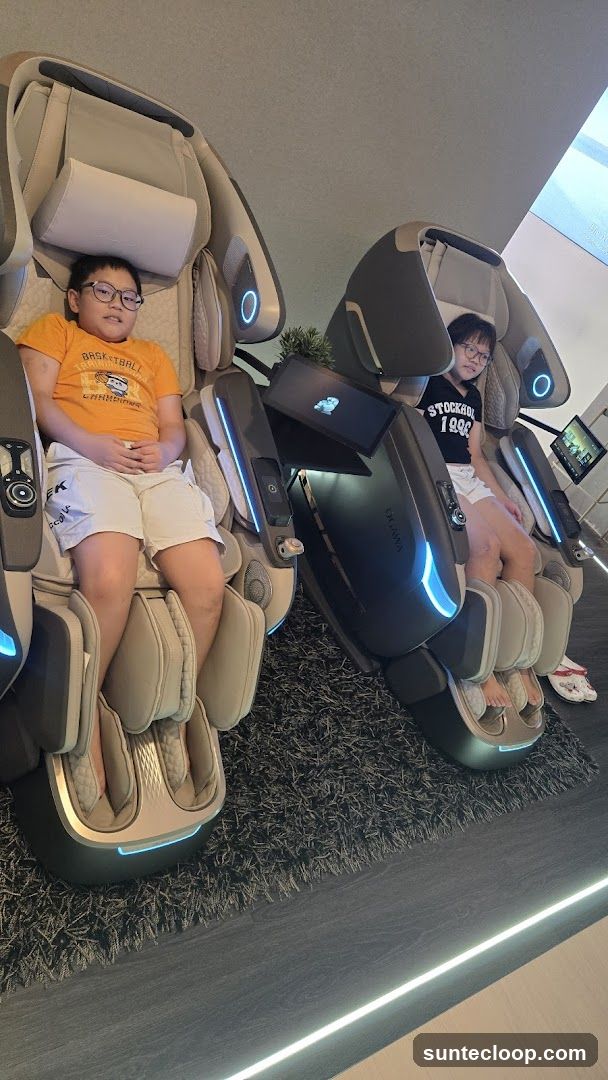 Two children sitting in massage chairs