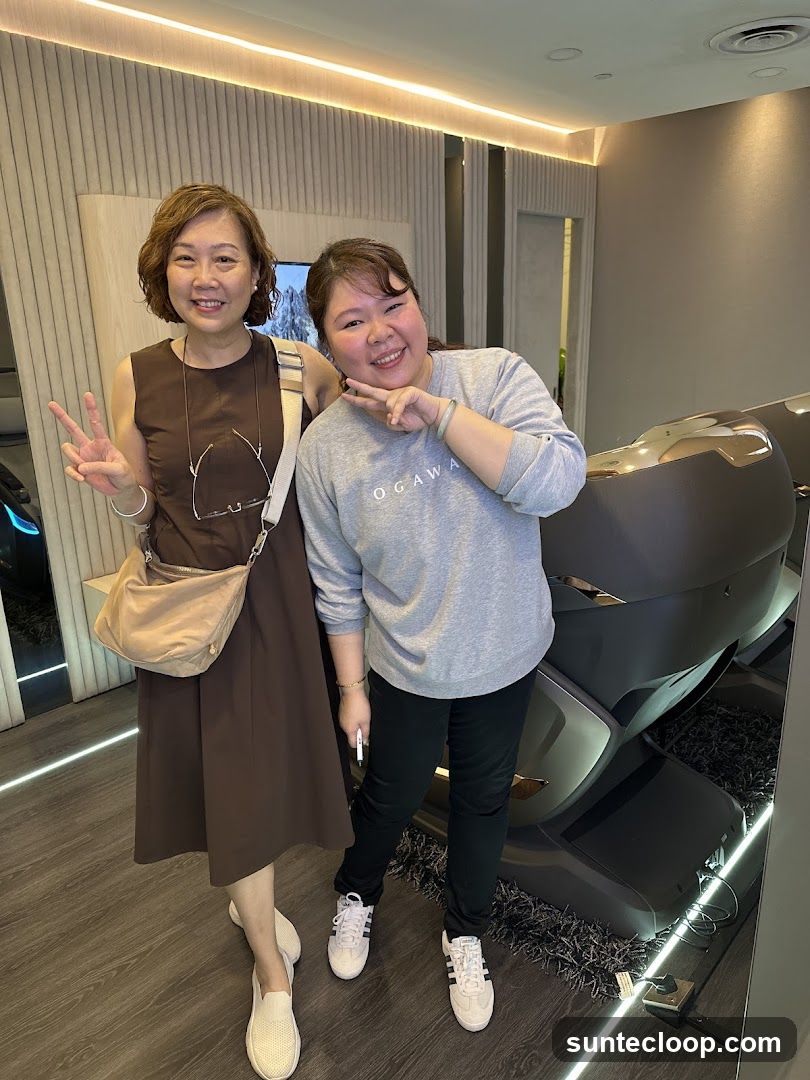 Two Women Posing by a Massage Chair