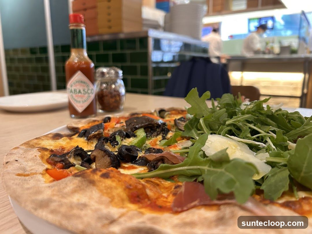 Pizza with toppings and salad