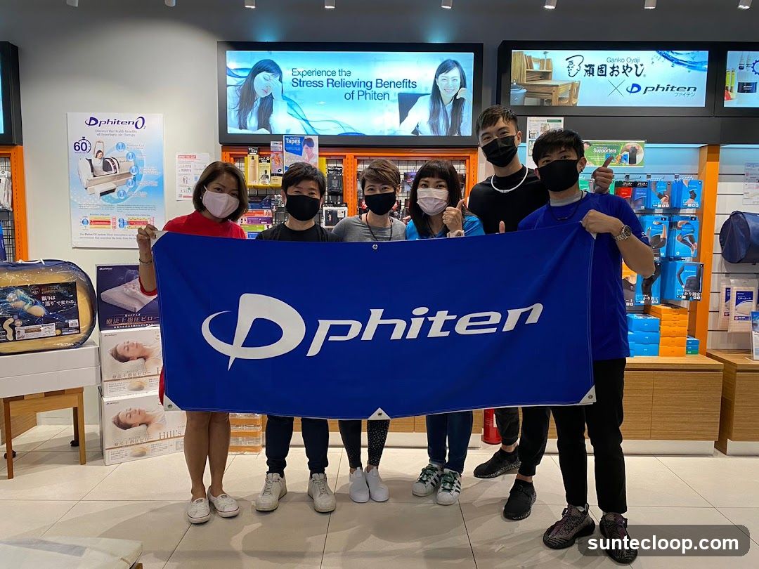Phiten Staff Holding a Banner