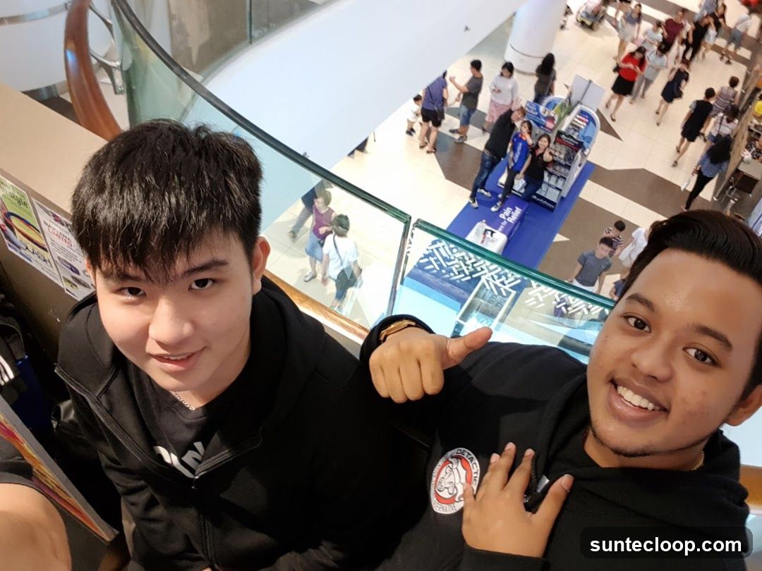 Two young men taking a selfie in a mall