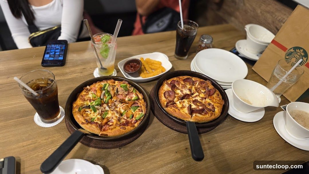 Pizzas and Drinks on Table