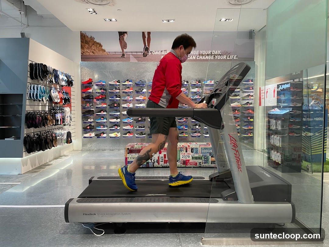 Man running on a treadmill in a shoe store
