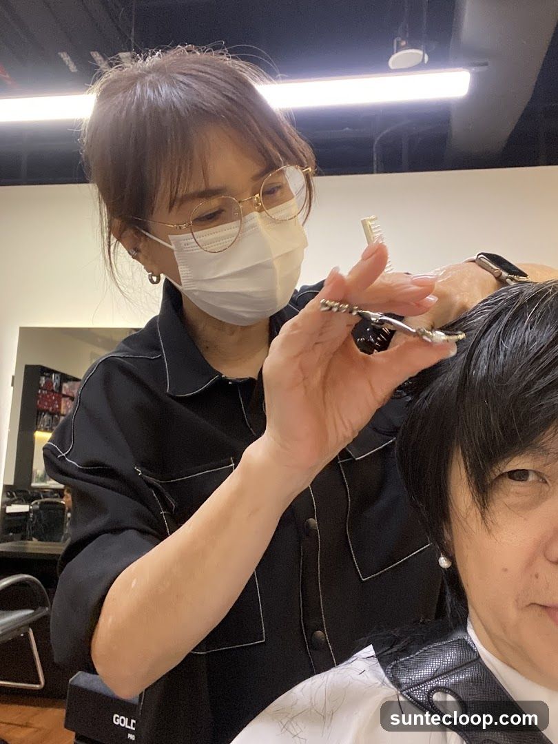 Hairdresser cutting client's hair